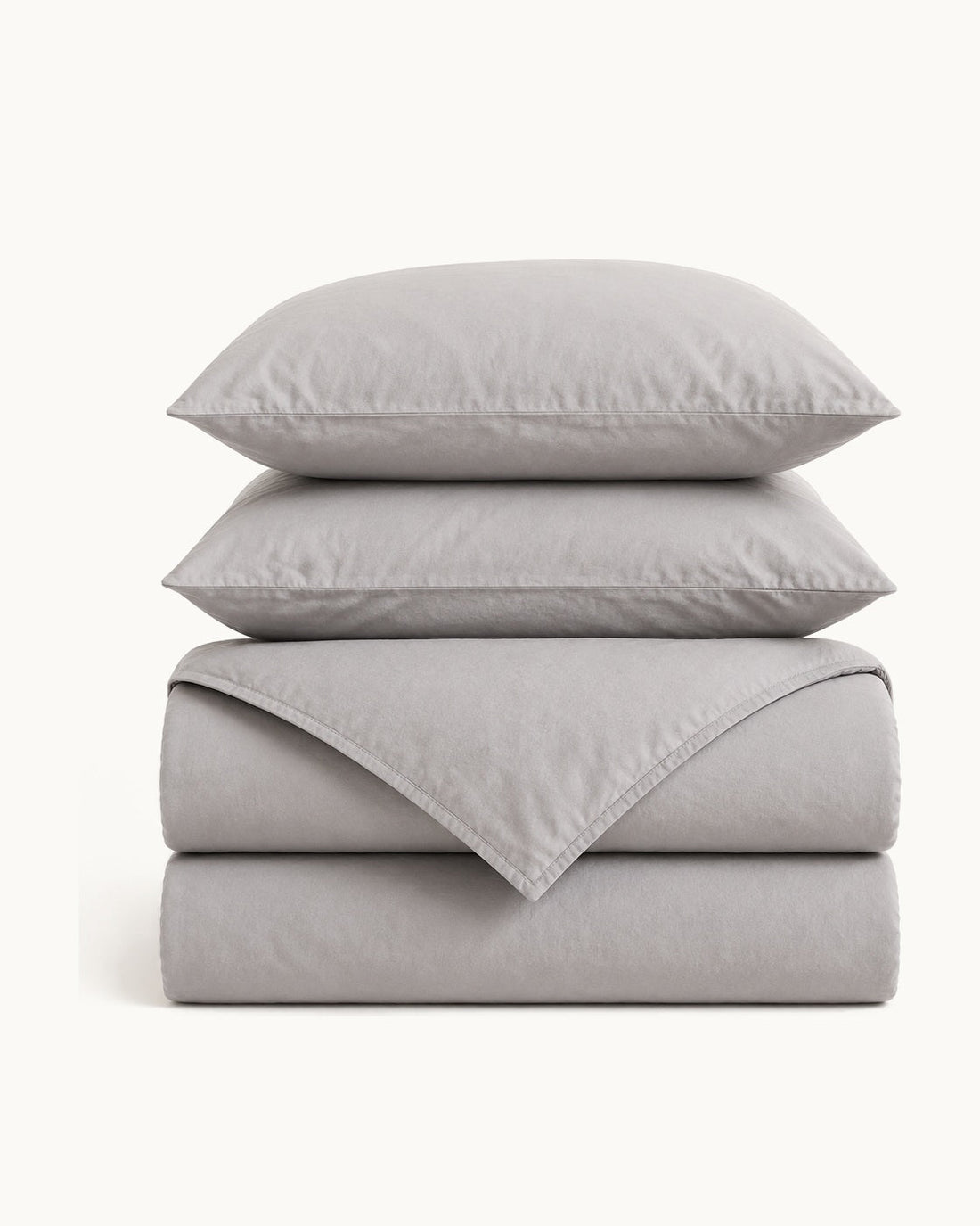 A folded textured cotton duvet cover, shown flat to compare against a comforter