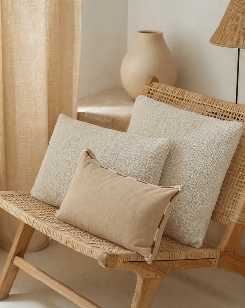 Bouclé Throw Pillow Cover — grouped with other cushions on a bench
