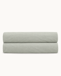 Cotton Percale Fitted Sheet, folded on a plain background with the elastic hem visible