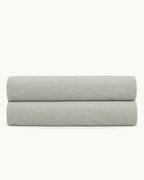 Cotton Percale Fitted Sheet, folded on a plain background with the elastic hem visible