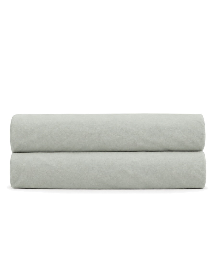 Cotton Percale Fitted Sheet, folded on a plain background with the elastic hem visible