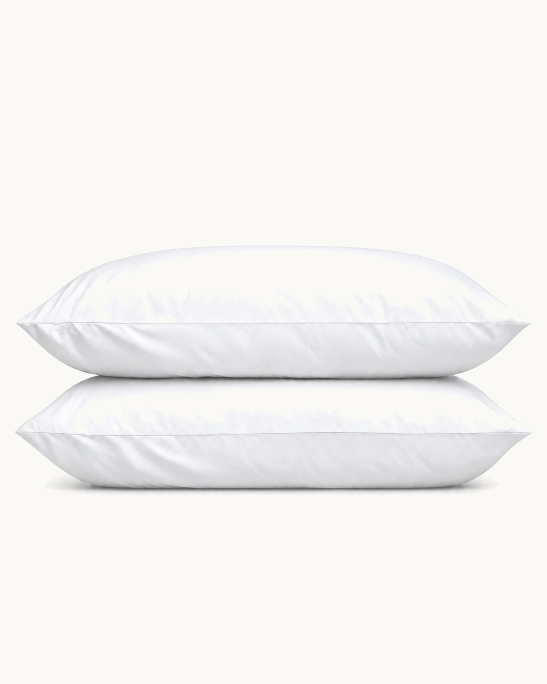 Cotton Sateen Pillowcases, one case on a pillow and one folded, on a plain background