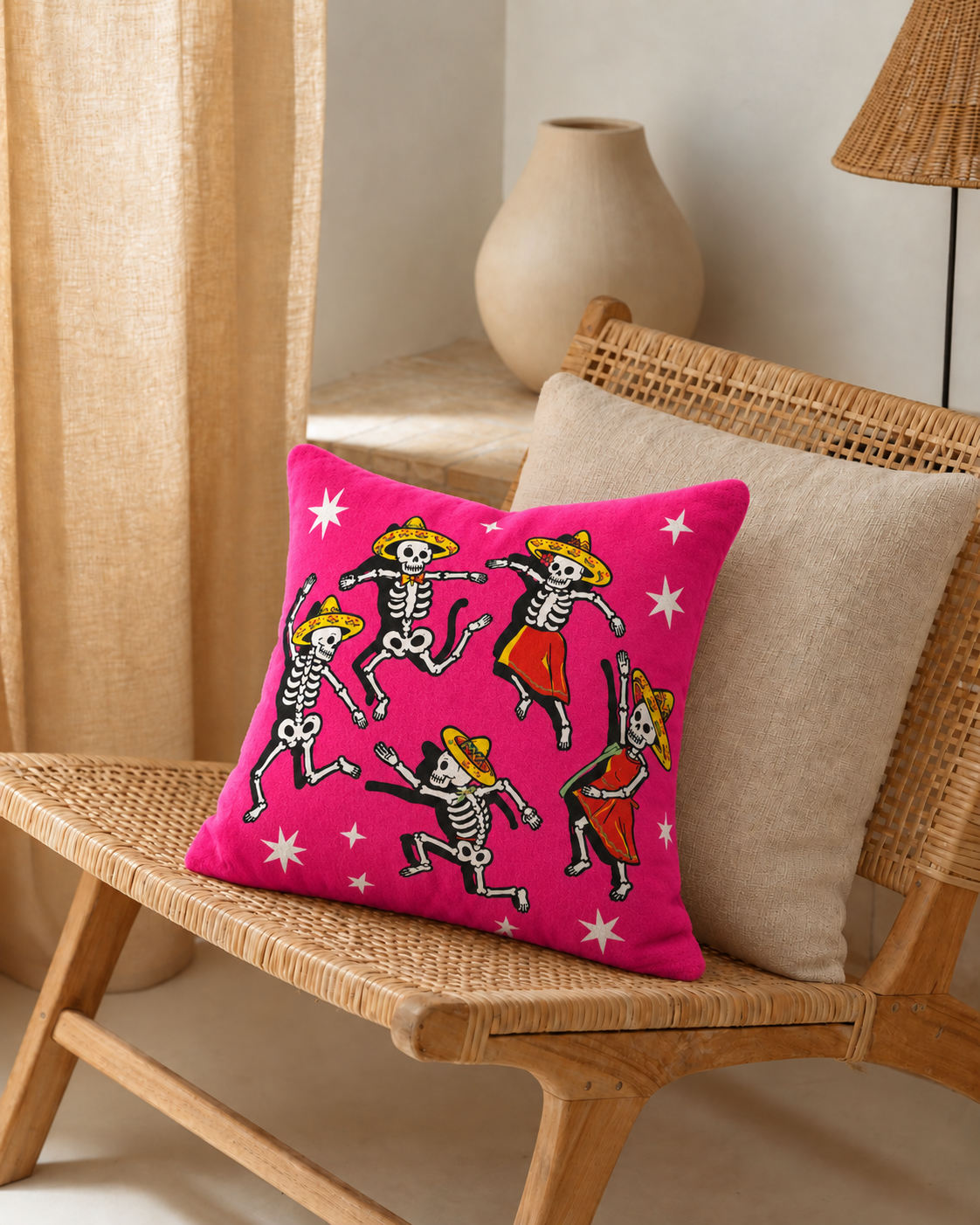 Dancing Skeletons Cotton Velvet Pillow Cover, on a rattan armchair