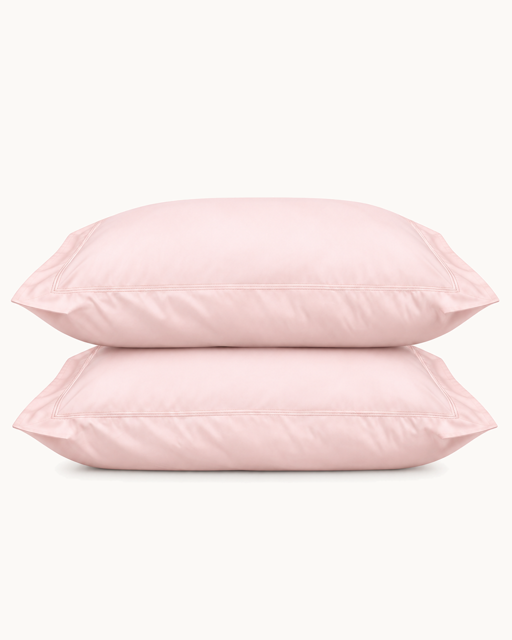 Egyptian Cotton Sateen Shams, one filled and one folded, the flange visible, on a plain background