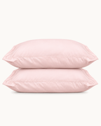 Egyptian Cotton Sateen Shams, one filled and one folded, the flange visible, on a plain background