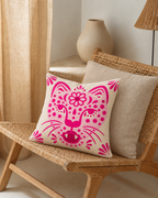 Folk Leopard Face Cotton Velvet Pillow Cover, on a rattan armchair