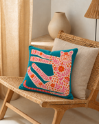 Folk Leopard Cotton Velvet Pillow Cover, on a rattan armchair