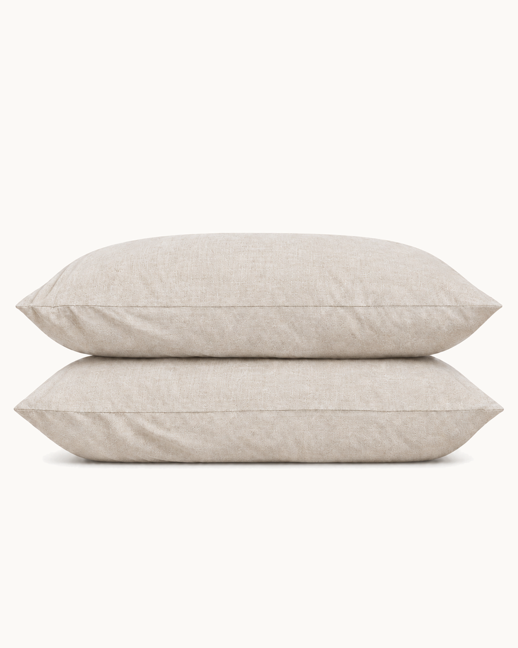 French Linen Pillowcases, one case on a pillow and one folded, on a plain background