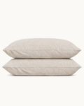 French Linen Pillowcases, one case on a pillow and one folded, on a plain background