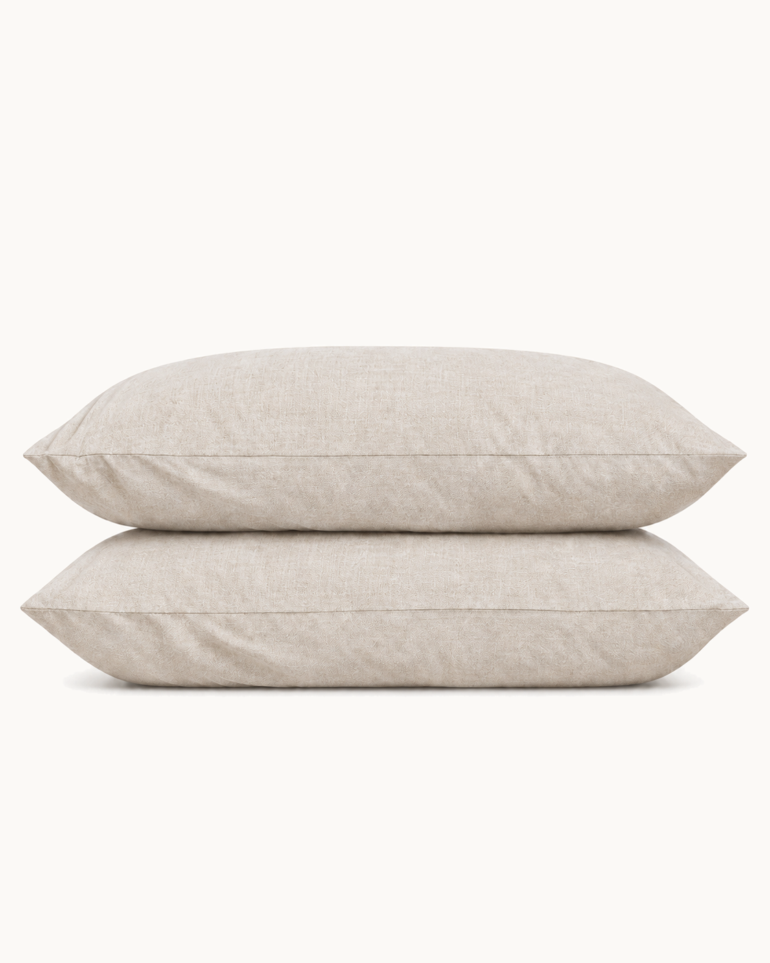 French Linen Pillowcases, one case on a pillow and one folded, on a plain background