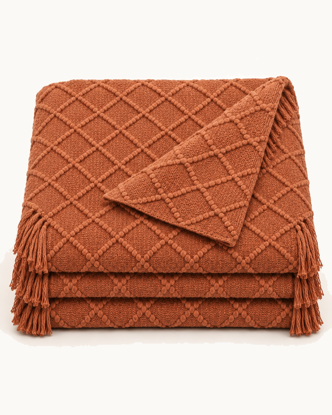 Fringed Knit Throw, folded on a plain background