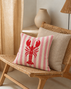 Lobster Stripe Cotton-Linen Pillow Cover, on a rattan armchair