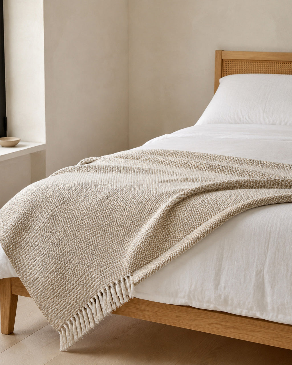 Basketweave Cotton Throw, folded across the foot of a bed