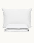 Cotton Percale Pillowcases, one case on a pillow, one folded, on a plain background
