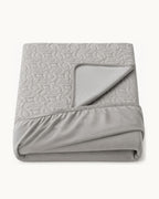 Quilted Mattress Protector — folded set on a plain background