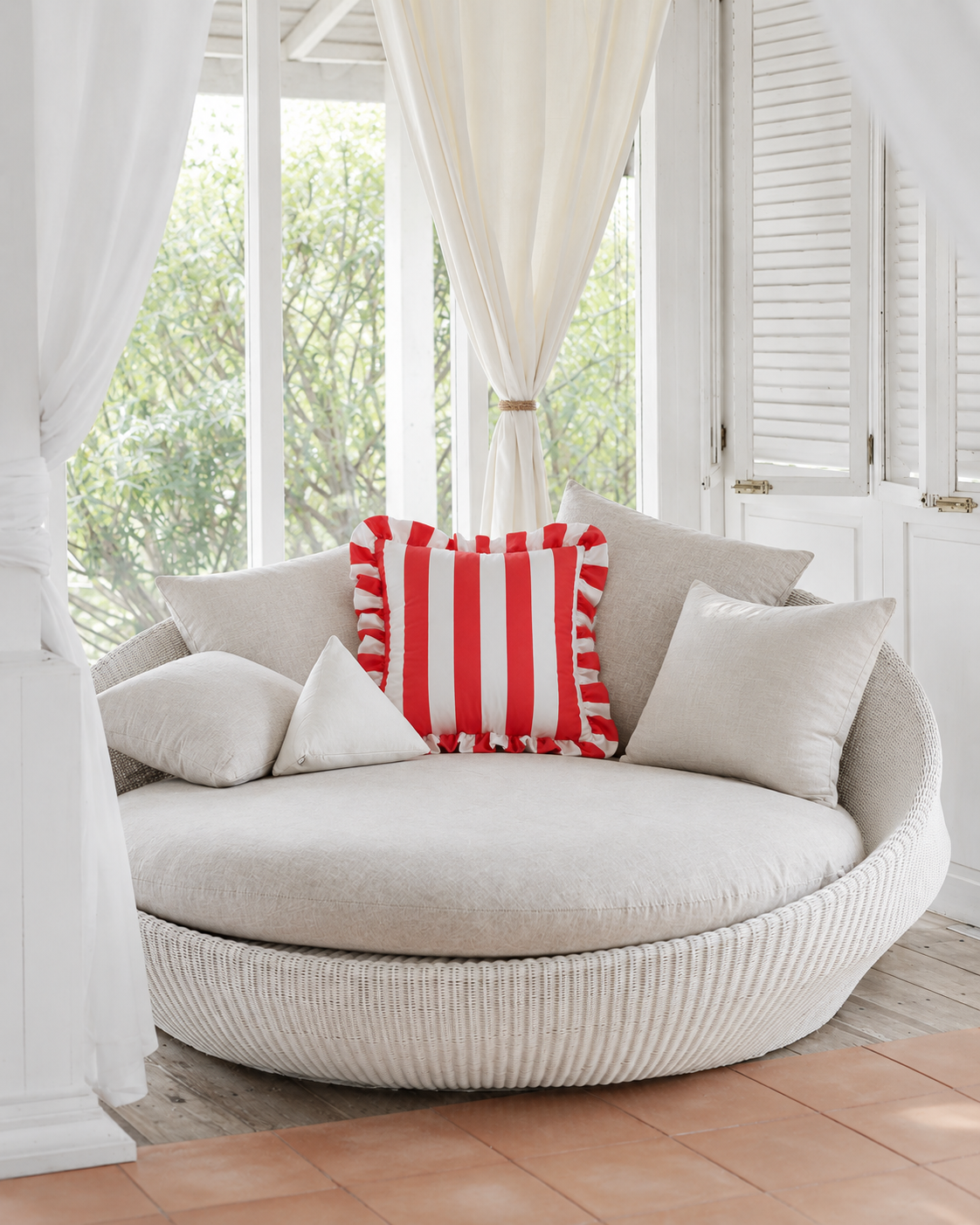Ruffled Cabana Stripe Cotton Sateen Pillow Cover in Red & White, on a rattan armchair