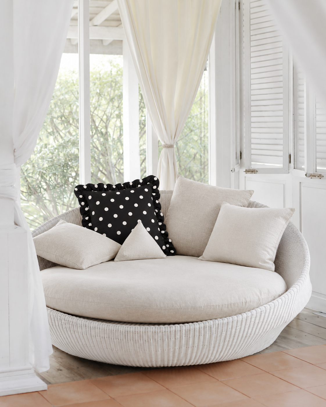 Ruffled Polka Dot Cotton Sateen Pillow Cover, on a rattan armchair