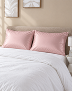 Sateen Pillowcases, Set of 2, on a made bed in morning light