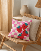 Strawberry Check Cotton-Linen Pillow Cover, on a rattan armchair