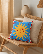 Sun Face Cotton-Linen Pillow Cover, on a rattan armchair