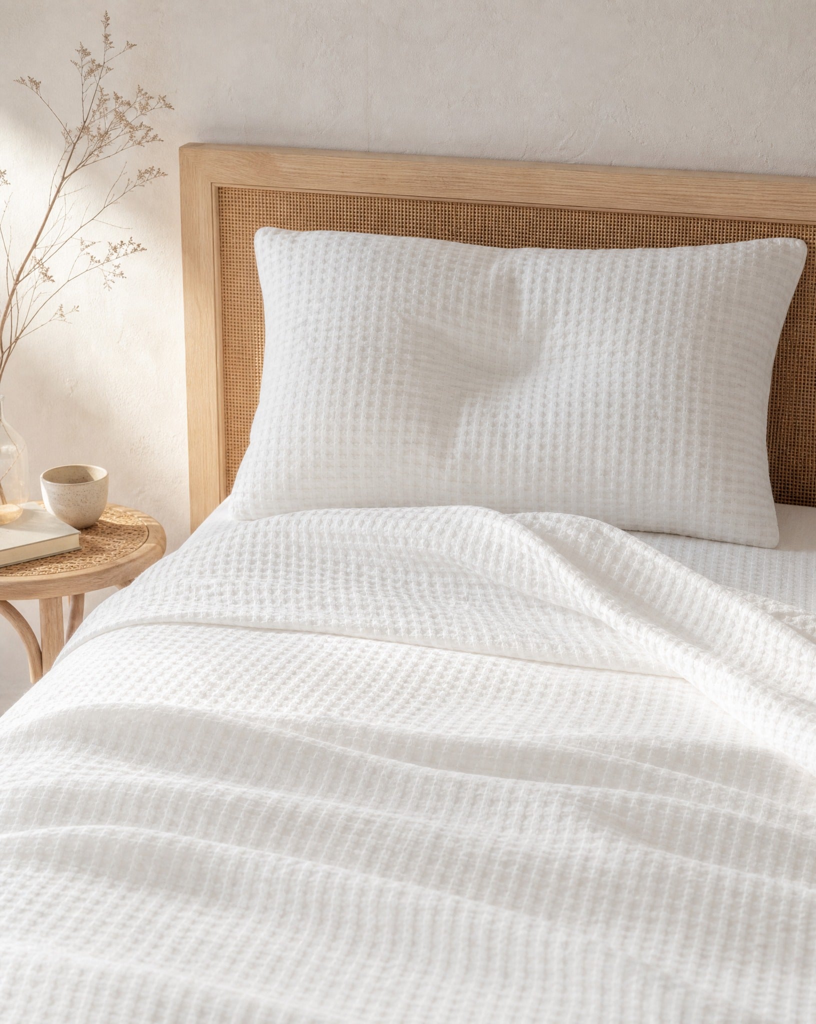 Waffle Cotton Coverlet — on a made bed, morning light