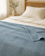 Waffle Knit Throw — on a made bed, morning light
