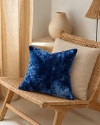 Washed Cotton Velvet Pillow Cover in Navy, on a rattan armchair